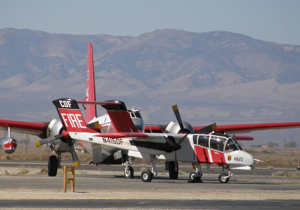 CALFIRE OV-10 Bronco air attack aircraft at Fox Field with a Lockheed P2V in background.